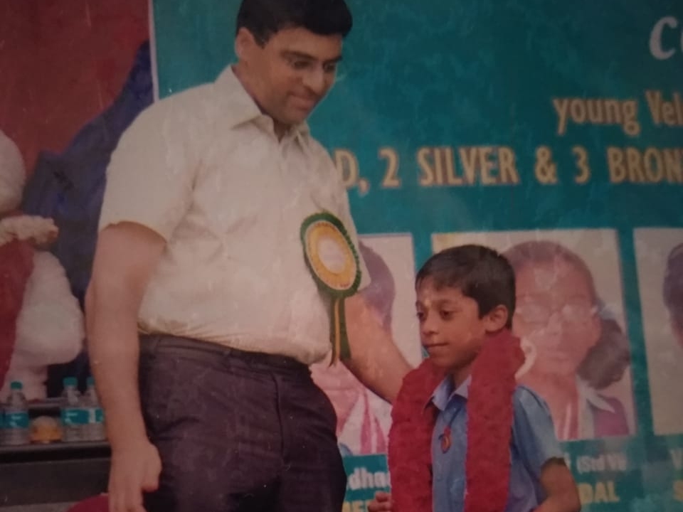 Vishwanathan Anand presents an award to a young Rameshbabu Praggnanandhaa.