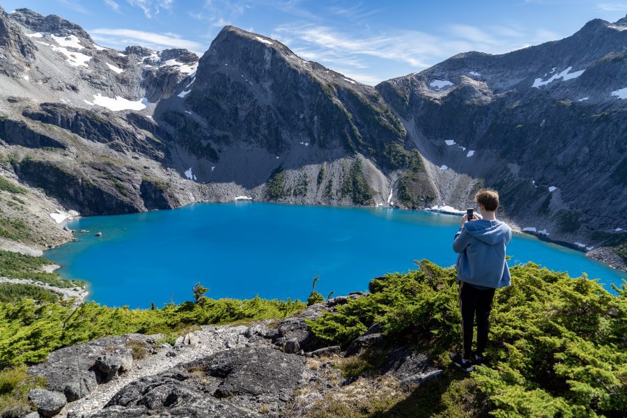 Boy above glacial lake Nimmo Bay British Columbia