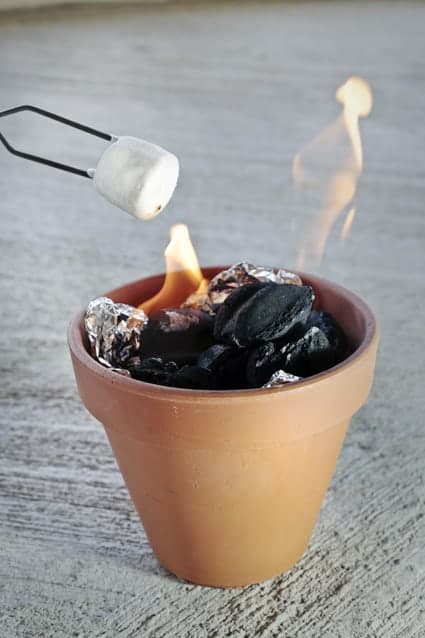 A tabletop campfire in a terra cot flower pot