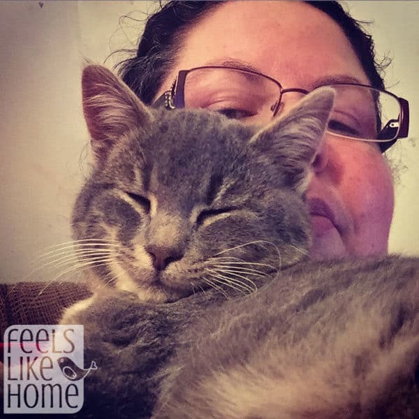 A close up of a woman and a kitten